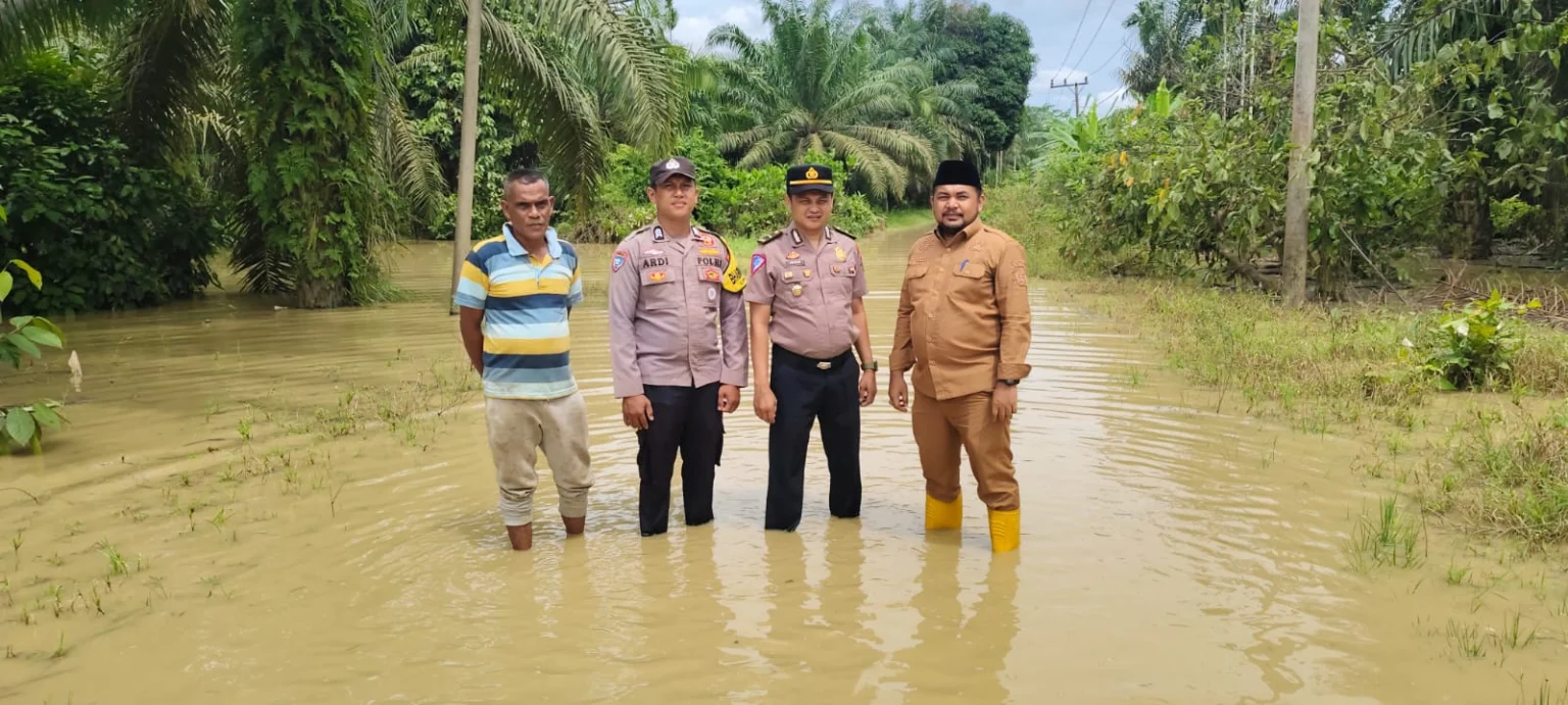 Kapolsek Bersama Camat Langkahan Monitoring Banjir Yang Disebabkan Oleh Intesitas Hujan Sehingga Meluapnya Ke Pemukiman Warga